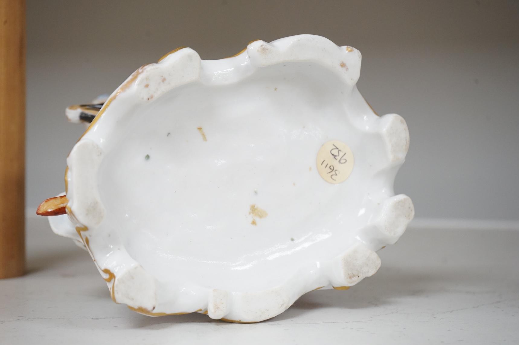 A German porcelain group of a seated sleeping beauty, 21cm high